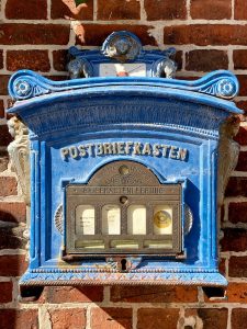 blue and gold wooden framed wall mounted mirror